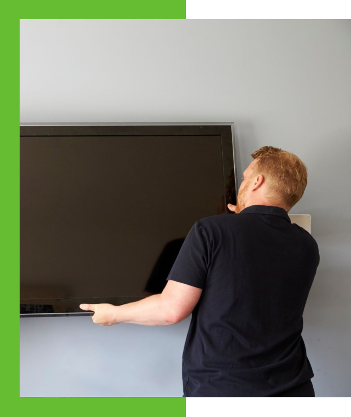 A person removing a television